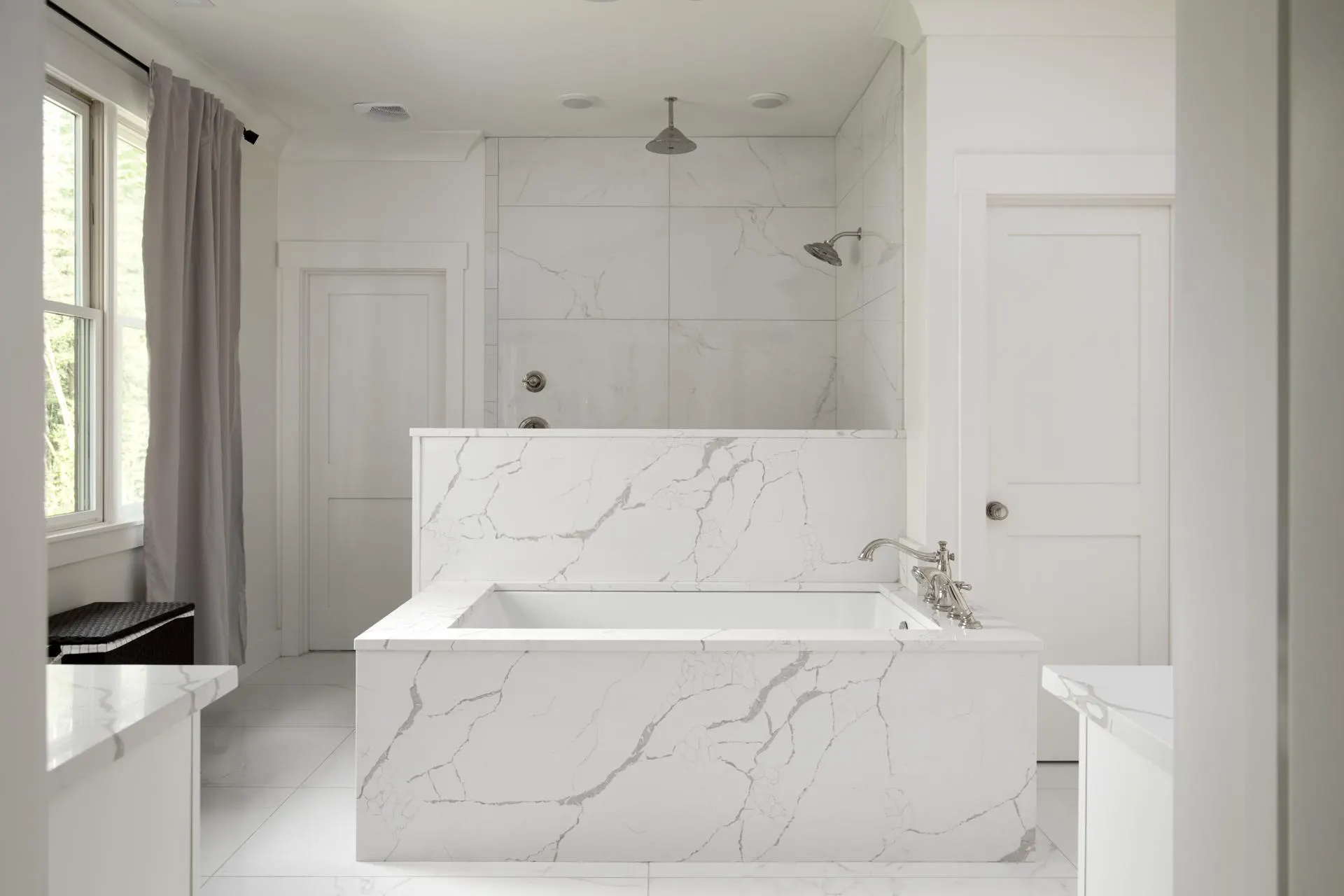 Primary bathroom with marble-look porcelain and a soaking tub